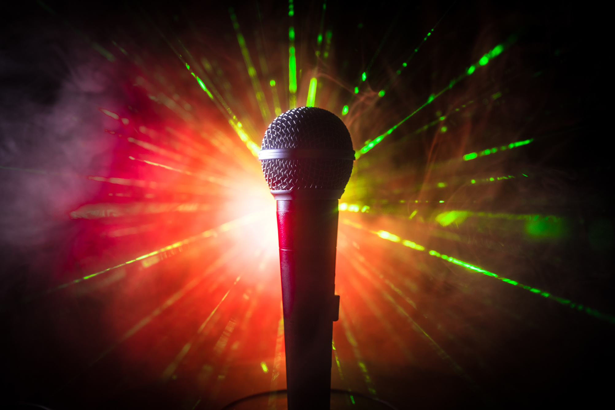 Microphone karaoke, concert . Vocal audio mic in low light with blurred background. Live music, audio equipment. Karaoke concert, sing sound. Singer in karaokes, microphones.